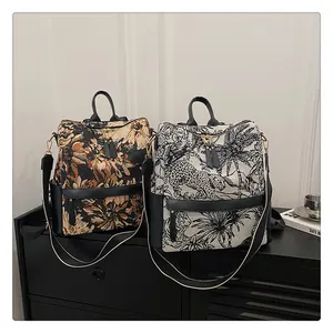 Détail de sacs à dos en jacquard à motifs floraux et léopard avec finitions en cuir noir