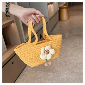Detailansicht der gelben geflochtenen Tasche mit einer großen weißen 3D-Stoffblume