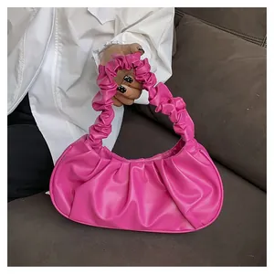 Macro detail of high-quality bright pink pleated PU leather handbag with soft textures