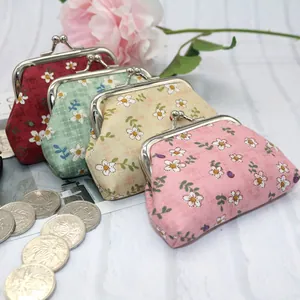 Set of four floral fabric coin purses with silver metal clasps and daisy print patterns