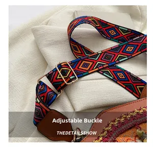 Close-up of ethnic geometric woven strap with gold buckle and brown leather end