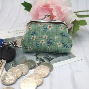 Detail of floral green plaid coin purse with silver metal kiss-lock clasp closure