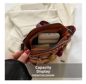 Detail shot of mini crossbody bucket bag interior with tassel and ethnic embroidery