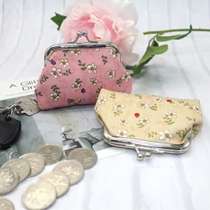 Floral print cloth coin purse with metal clasp closure and cotton canvas texture