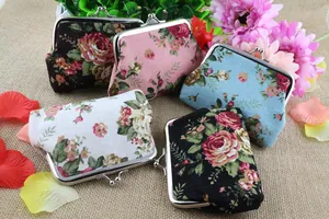 Detail view of vintage canvas coin purses with floral rose prints and metal kiss lock