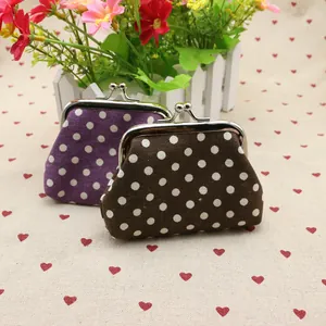 Macro view of vintage polka dot canvas coin purses with silver metal kiss-lock clasps
