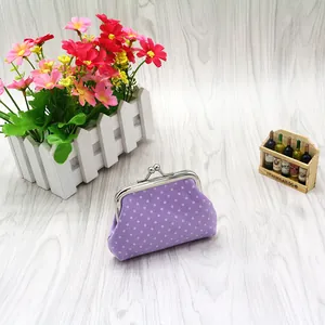 Close-up of a purple polka dot cotton coin purse with a vintage silver metal clasp
