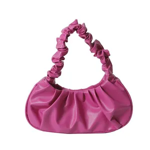 Magenta ruched crescent handbag with pleated texture and stylish ruffled handle