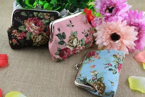 Close-up of vintage canvas rose floral coin purses with classic metal clasp closure