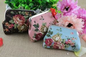 Detail of vintage canvas coin purses with floral patterns and silver metal clasp closure