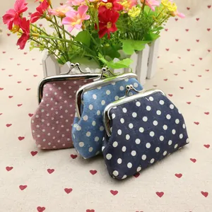 Detailed view of three polka dot fabric coin purses with vintage metal clasp closures