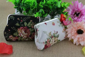 Detail showing vintage canvas coin purses with floral patterns and silver metal clasps