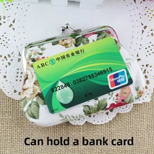 Detail view of floral canvas coin purse with silver metal clasp showing bank card capacity