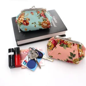 Floral canvas coin purses showing storage capacity for lipstick, keys, and cards