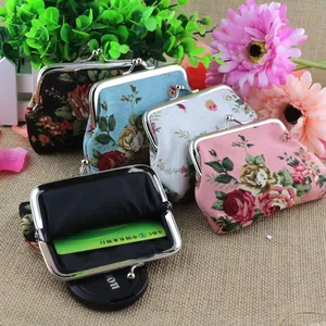 Detail of vintage floral canvas coin purses showing metal clasp and card storage capacity