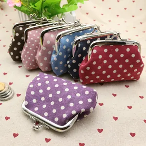 Detailed view of colorful polka dot canvas coin purses with vintage metal clasp closure