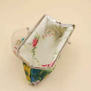 Détail d'un porte-monnaie rétro avec fermoir à baiser et doublure à motif floral