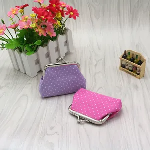 Close-up of pink and purple polka dot mini coin purses with vintage metal kiss-lock clasp