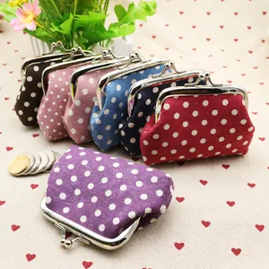 Detailed group shot of polka dot fabric coin purses with vintage metal clasp closure