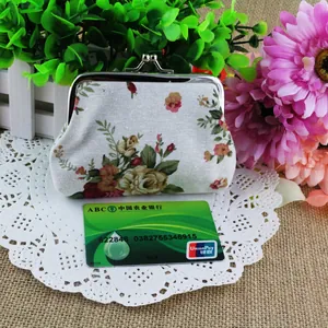 Detail of vintage canvas coin purse with rose print and metal kiss-lock closure