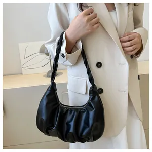 Detailed view of black pleated leather hobo bag with a stylish woven handle for women