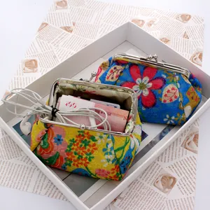 Internal view of floral fabric coin purse storing banknotes and wired earphones