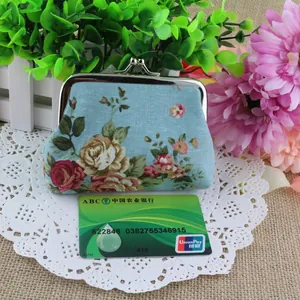 Detail of canvas coin purse with vintage rose print and metal clasp closure