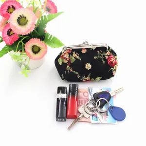 Floral canvas coin purse with metal clasp showing lipstick, keys, and cash capacity
