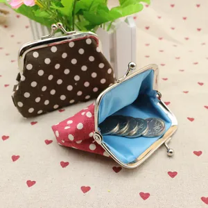 Detailed macro view showing metal clasp and inner lining of polka dot coin purses