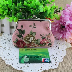Detail view of floral canvas coin purse with silver metal clasp and pink rose pattern