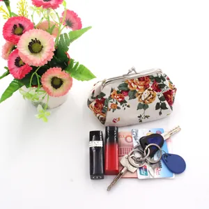 Detailed internal storage of floral canvas coin purse with cards and metal clasp