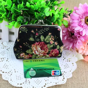 Close-up of vintage canvas rose coin purse with kiss-lock closure and card size reference