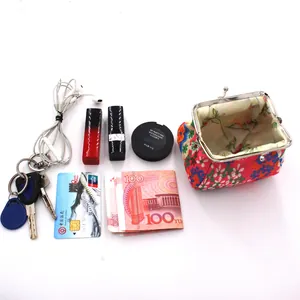 Top view of vintage floral coin purse shown with lipstick and keys for size reference