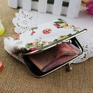 Detail view of floral canvas coin purse showing interior capacity and silver metal clasp