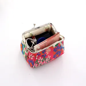 Top view of embroidery coin purse showing inner capacity with floral fabric and kiss-lock