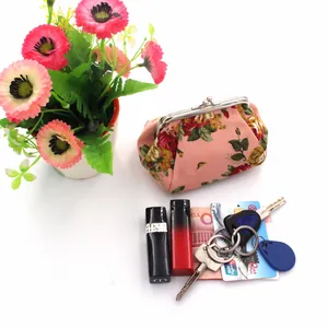 Close-up of vintage pink floral canvas coin purse with silver metal kiss-lock closure