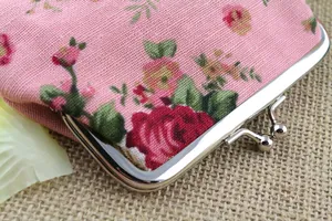 Close-up of vintage floral canvas coin purse with classic silver metal clasp detail