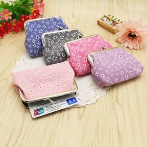 Floral print clasp coin purses in five pastel colors on a rustic wooden table background