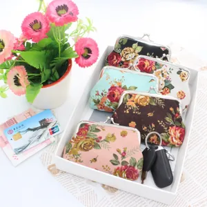Set of five vintage floral canvas coin purses with metal clasps and rose patterns