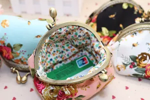 Détail du porte-monnaie en toile florale montrant la capacité intérieure avec carte