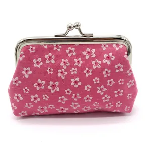 Close-up of floral pattern coin purse with silver metal kiss-lock clasp in rose red