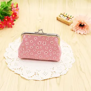 Close-up of pink cherry blossom canvas coin purse with silver metal kiss-lock clasp