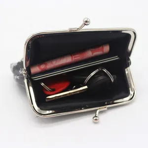 Close-up of floral coin purse showing interior storage for cash, cards, and keys