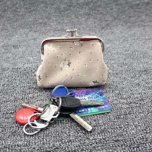 Close-up of vintage floral cotton coin purse with silver metal kiss-lock closure