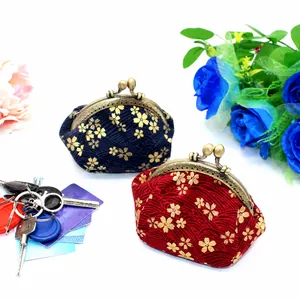 Detail of Japanese fabric coin purses with cherry blossom pattern and metal clasp closure