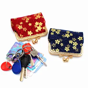 Japanese style brocade coin purse with golden cherry blossom pattern and kiss lock