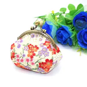 Detail of vintage floral fabric purse with retro bronze metal frame clasp closure