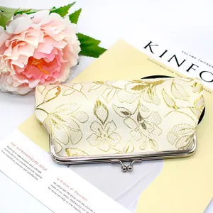 Vintage cream clutch bag with gold floral embroidery and metal kiss lock closure