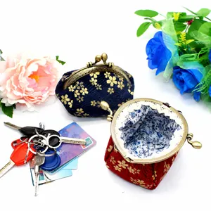 Japanese style fabric coin purse with gold floral pattern and vintage metal clasp closure