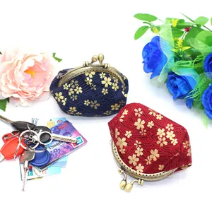 Detail view of Japanese style fabric coin purses with golden cherry blossom patterns